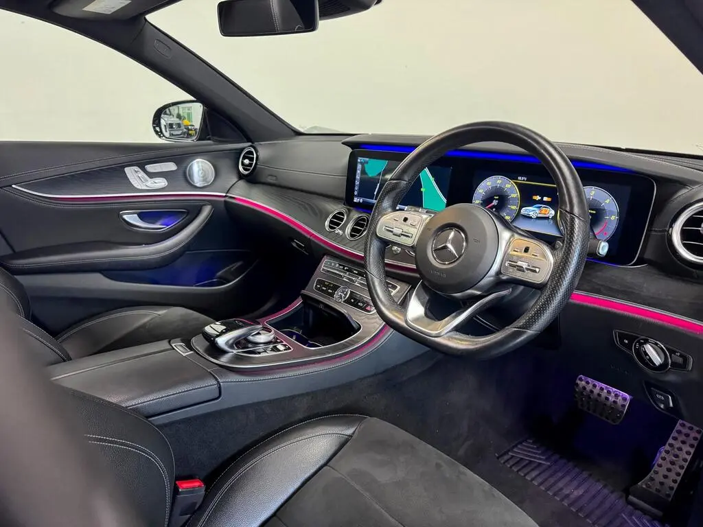 Rear seat view of Business Class vehicle with leather seating and ambient lights