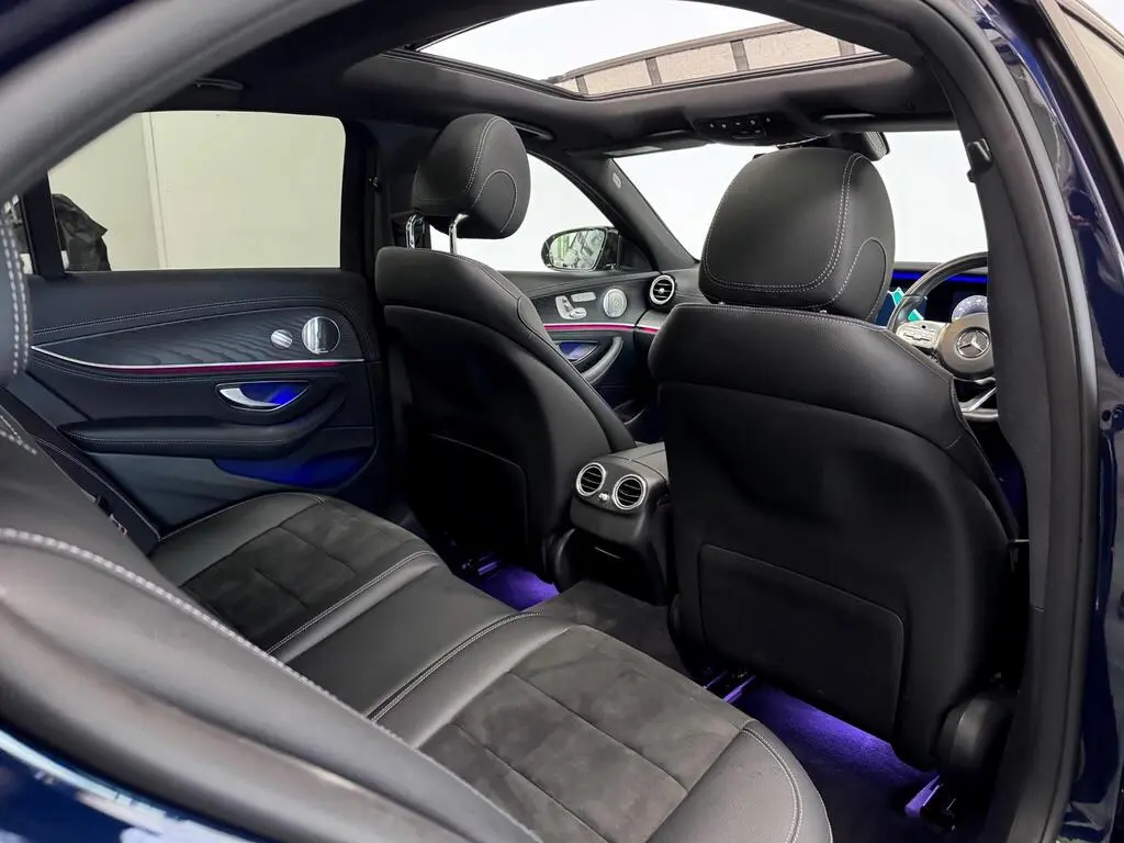 Rear seat view of Business Class vehicle with leather seating and ambient lights