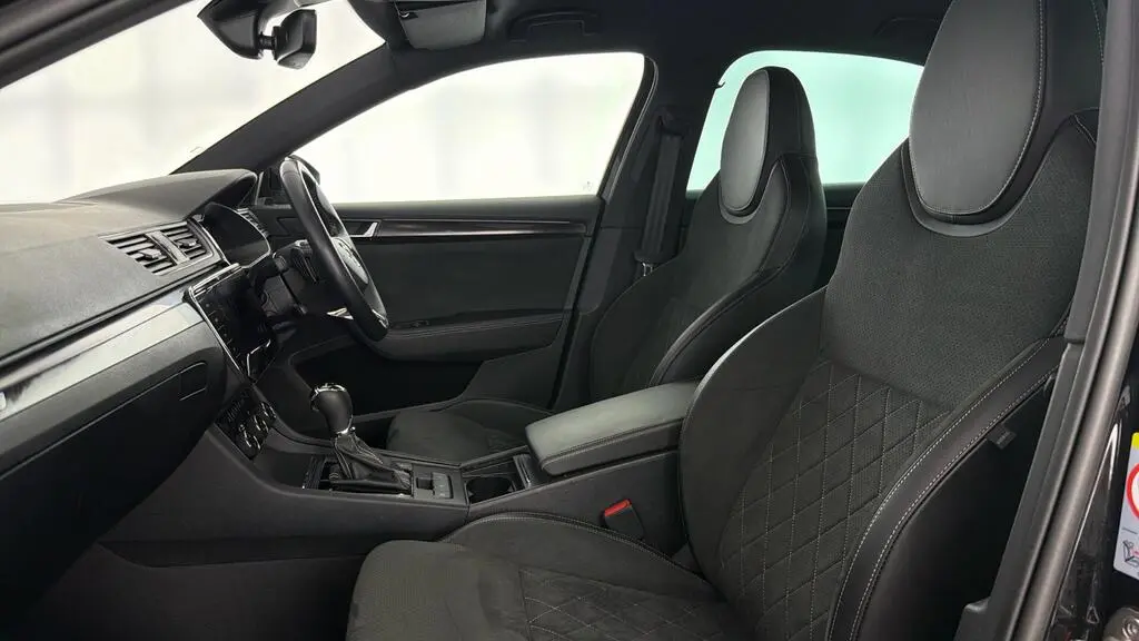 Side view of comfort class chauffeur car interior with stitched leather and front cabin