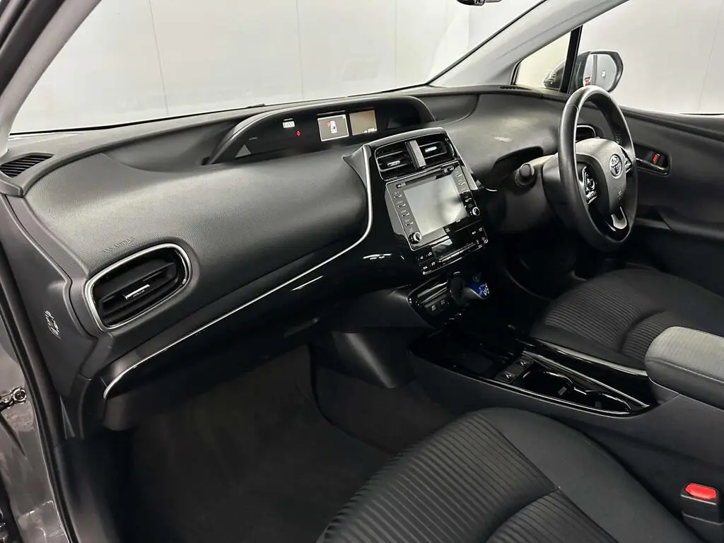 Passenger view of dashboard and cabin layout in chauffeur-driven economy hire vehicle