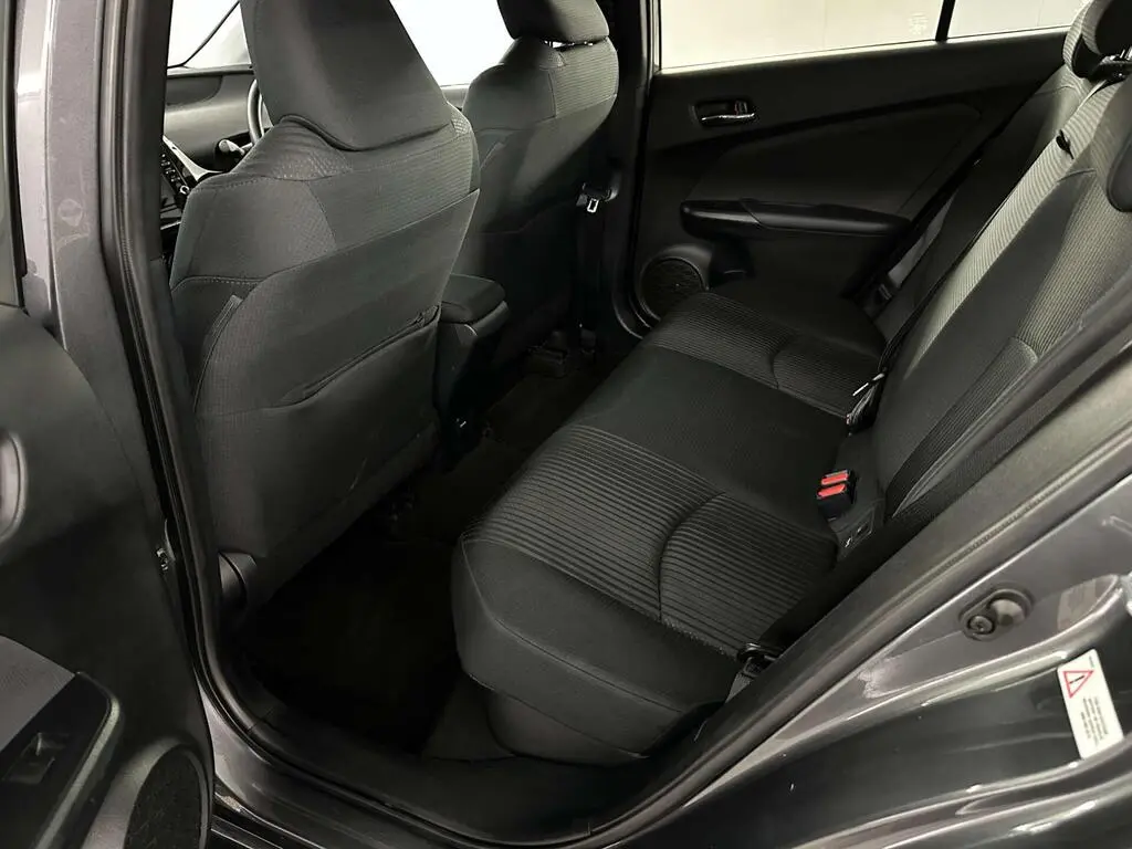 Full rear seat view in an economy class hire car, with clean black fabric upholstery