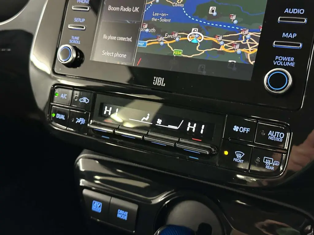 Dashboard showing navigation and dual-zone climate control system in economy class car