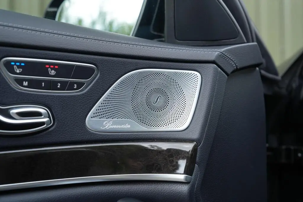 Brushed metal Burmester speaker and heated seat controls on door panel
