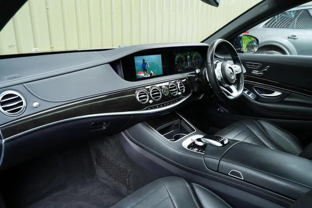 High-end dashboard with touchscreen, ambient lighting and wood trim